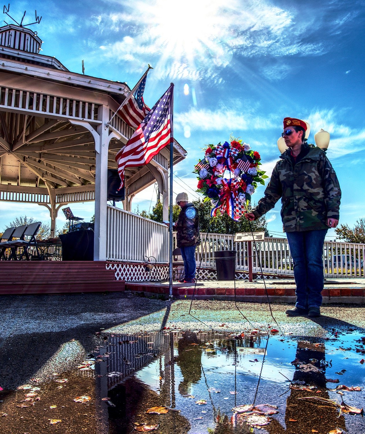 With the wind occasionally whipping up, marine veteran Jenni Biesheuvel makes sure the memorial wreath has no chance of falling over. [view more vets]